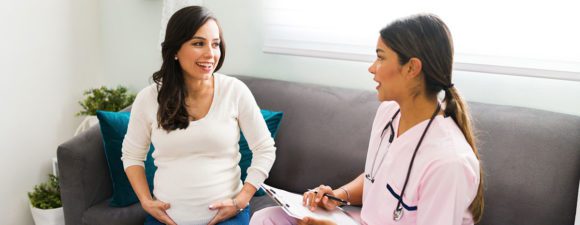 Pregnant woman consults with midwife